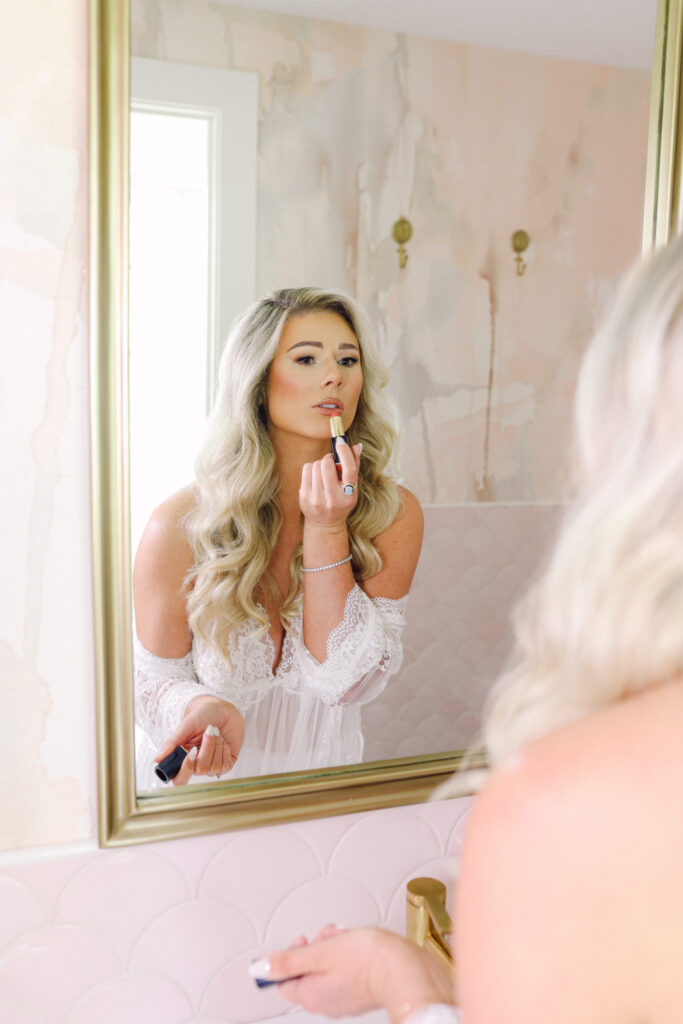 Bride putting on lipstick