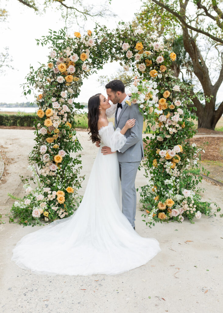 Bride and Groom with wedding ceremony arch at Lowndes Grove