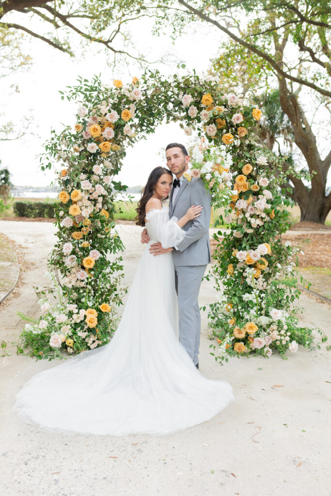 Bride and Groom with wedding ceremony arch at Lowndes Grove