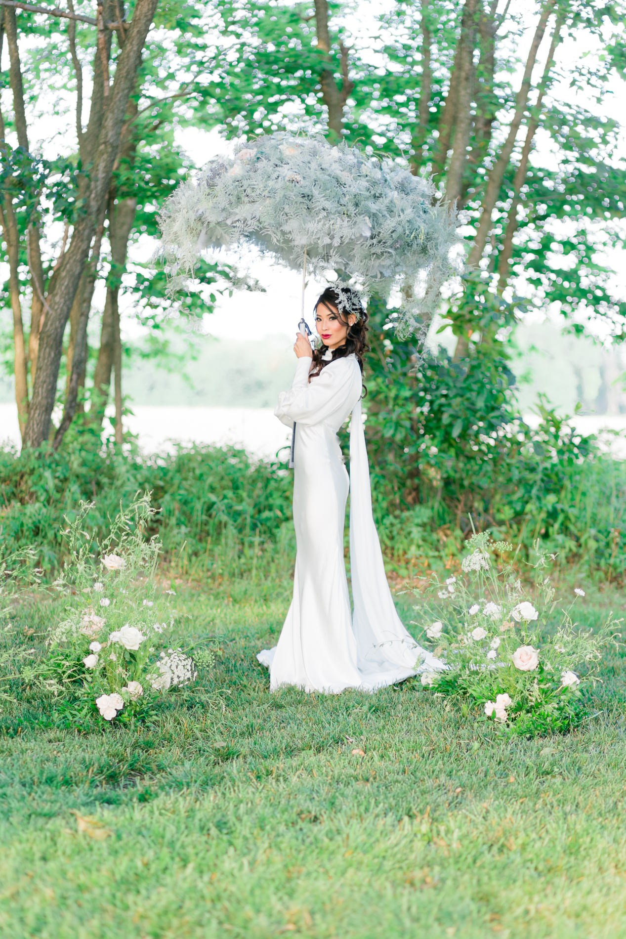 bride holding blue and white floral parasol